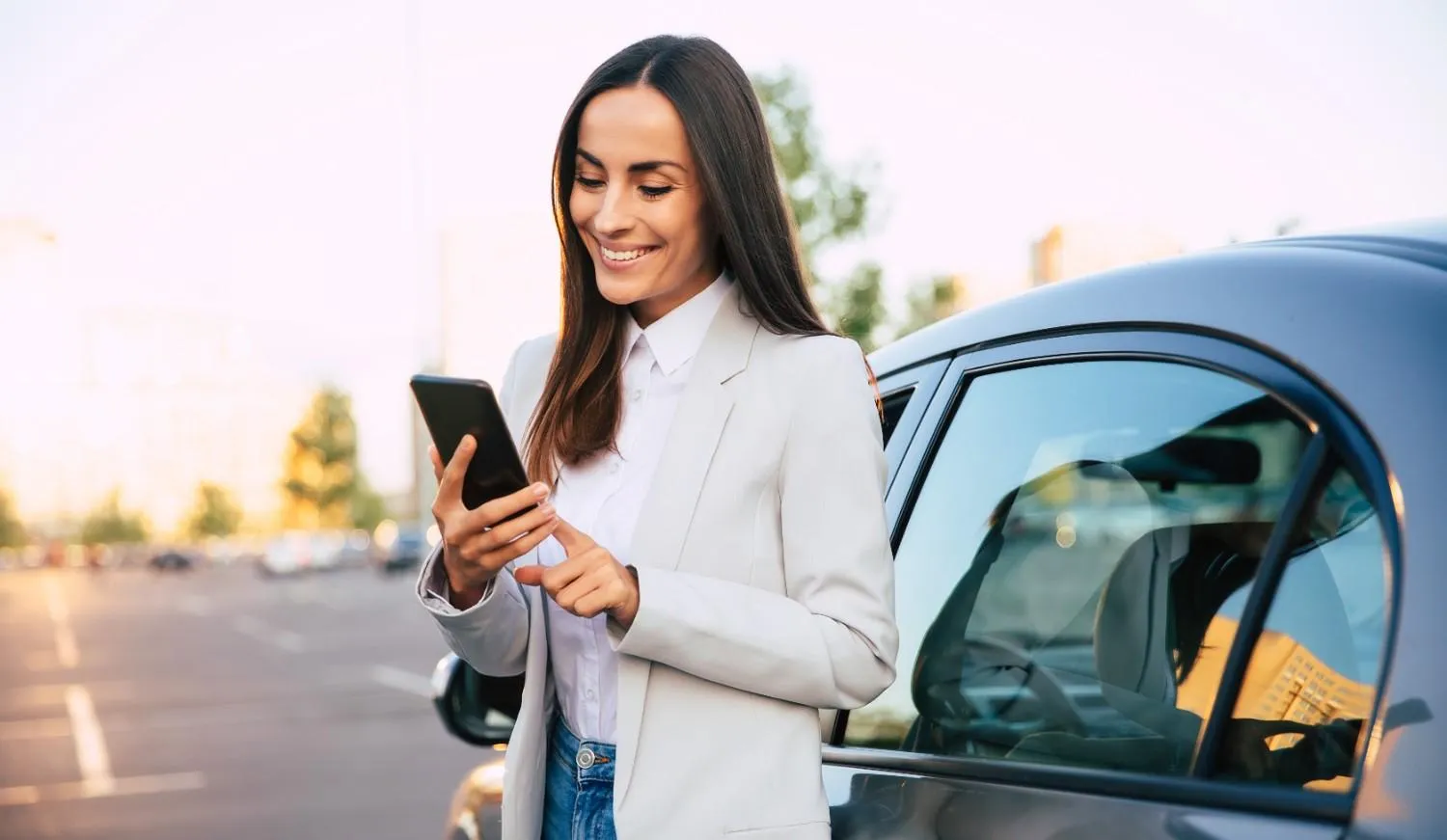 Driver checking phone with car keys on a table